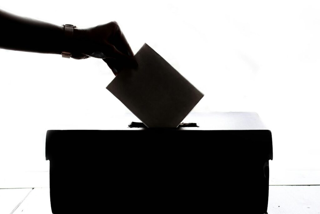 A voter placing a ballot in a ballot box