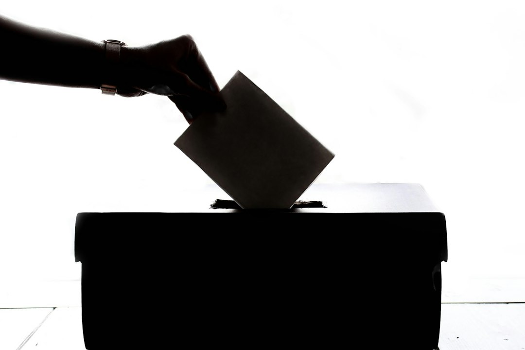 A voter placing a ballot in a ballot box